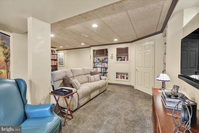 carpeted living area with recessed lighting, crown molding, and baseboards