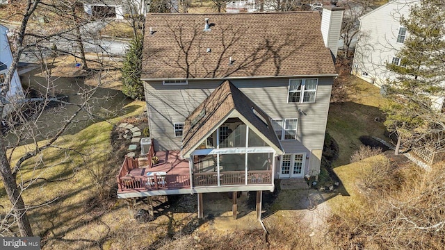 rear view of property with a shingled roof, french doors, a chimney, and a wooden deck