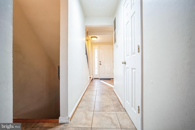 hall with light tile patterned floors