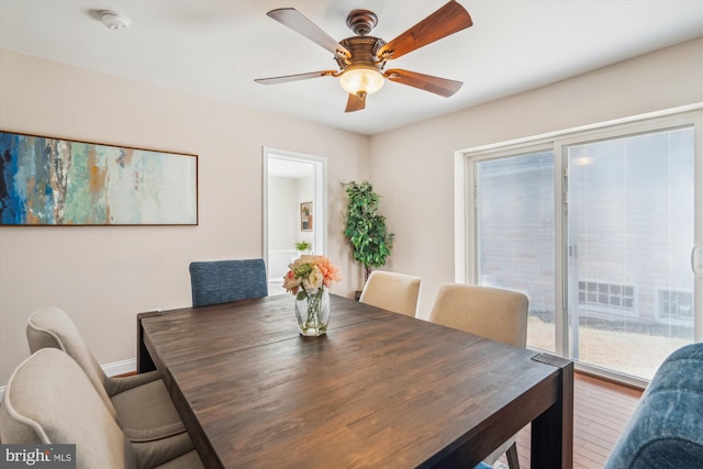 dining space with baseboards and ceiling fan