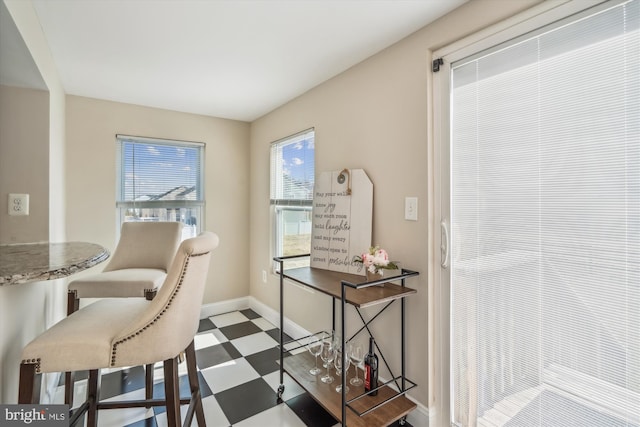 dining room featuring tile patterned floors and baseboards