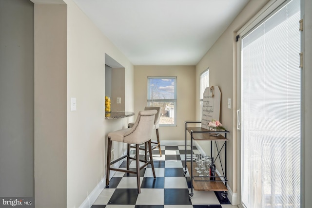 dining area featuring tile patterned floors and baseboards