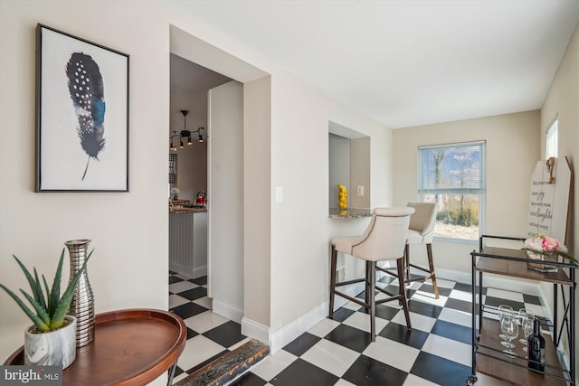 dining space featuring tile patterned floors, baseboards, and a wealth of natural light