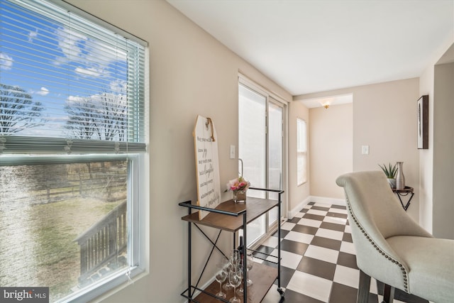 interior space with tile patterned floors and baseboards