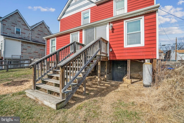 back of house featuring fence