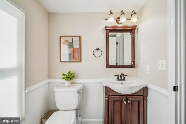 bathroom featuring toilet and vanity