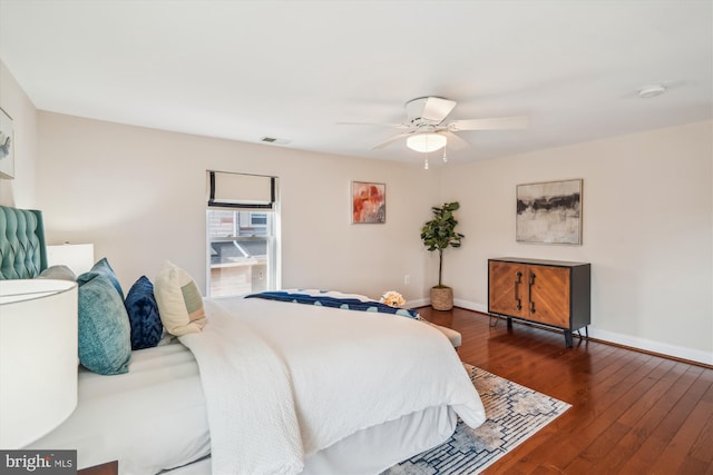 bedroom featuring hardwood / wood-style floors, baseboards, visible vents, and a ceiling fan