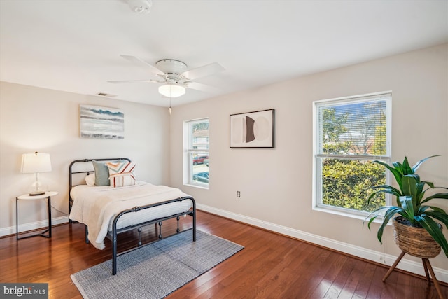 bedroom with baseboards, a ceiling fan, and hardwood / wood-style flooring