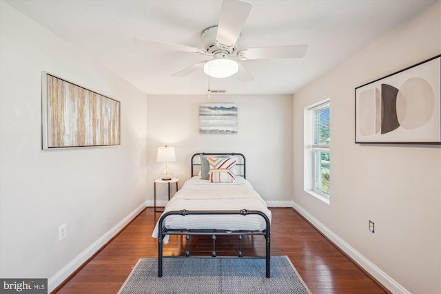 bedroom featuring visible vents, baseboards, and hardwood / wood-style floors