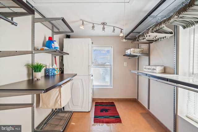 laundry room with light tile patterned floors, baseboards, and laundry area