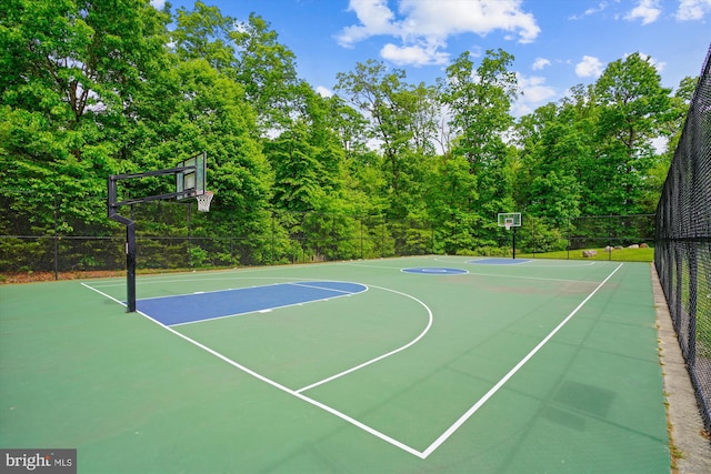 view of basketball court with community basketball court and fence