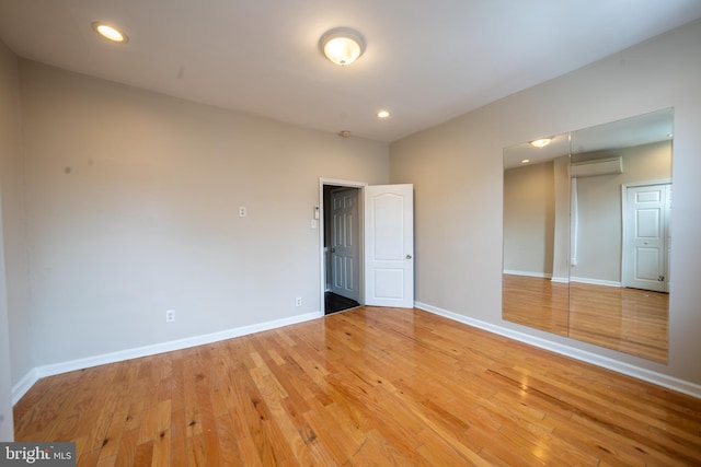 empty room with light hardwood / wood-style floors