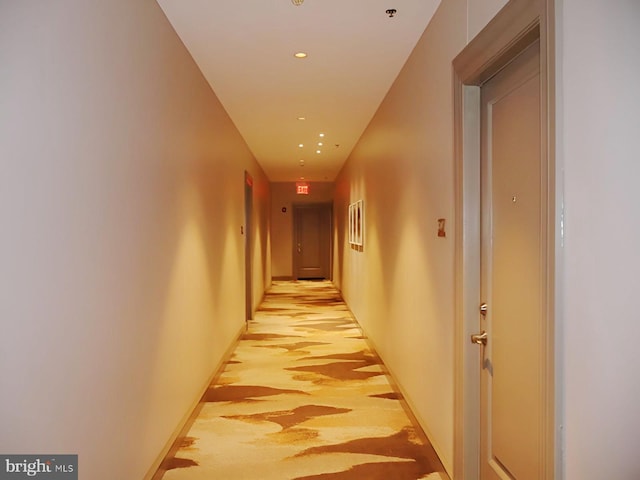 hallway featuring baseboards and recessed lighting