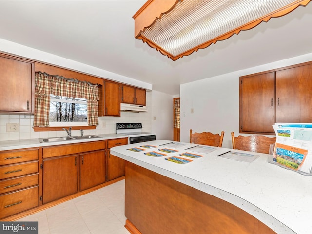 kitchen featuring range with electric cooktop, sink, light tile patterned floors, and backsplash