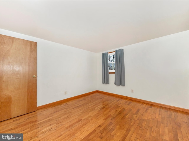 spare room with light hardwood / wood-style flooring