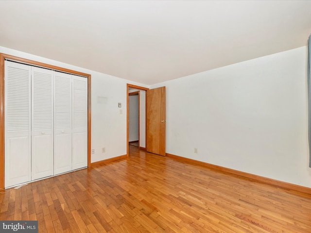 unfurnished bedroom featuring a closet and light hardwood / wood-style flooring