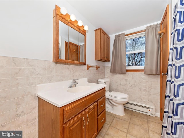 bathroom with vanity, tile walls, baseboard heating, and toilet