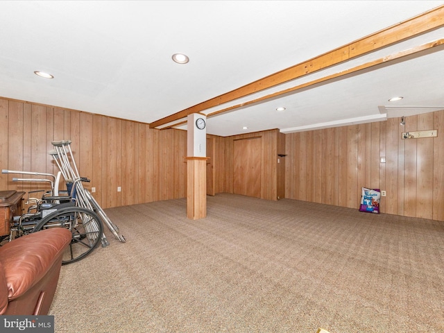 workout room featuring carpet flooring and wood walls