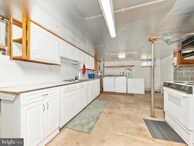 kitchen featuring sink, white electric range, white cabinets, and independent washer and dryer