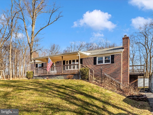 ranch-style house with a front yard and covered porch