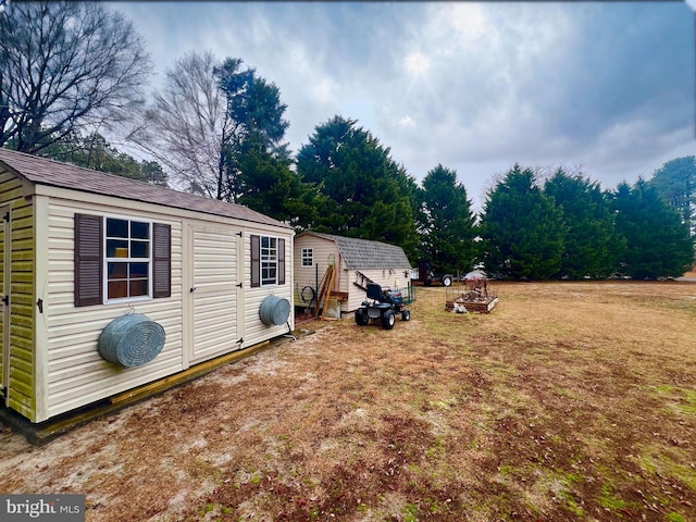 back of property featuring a lawn and a shed