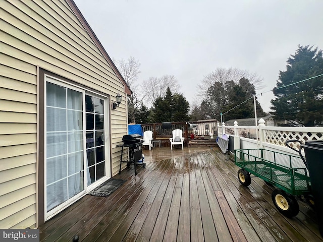 wooden deck featuring a grill