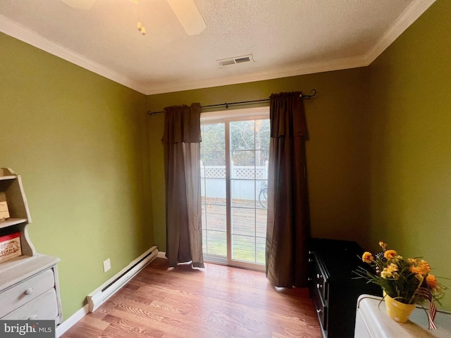 interior space featuring a baseboard radiator, ornamental molding, a textured ceiling, and light hardwood / wood-style flooring