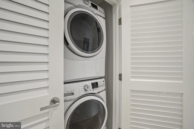 laundry room featuring laundry area and stacked washer and clothes dryer