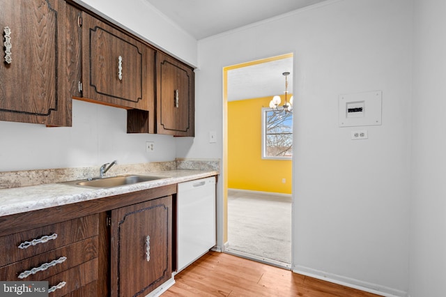 kitchen with sink, light hardwood / wood-style flooring, hanging light fixtures, dark brown cabinets, and white dishwasher