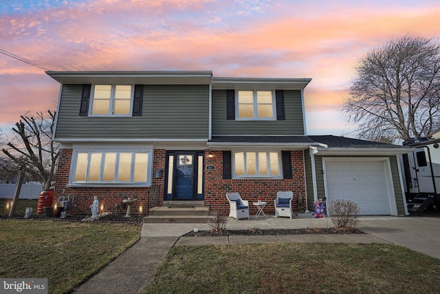 view of front facade with a garage and a lawn