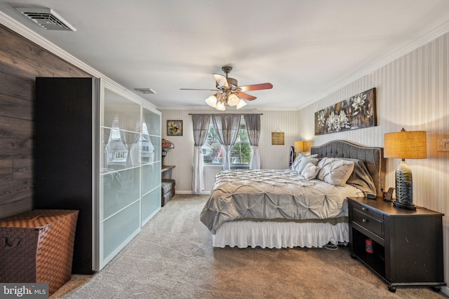 bedroom with crown molding, ceiling fan, and carpet