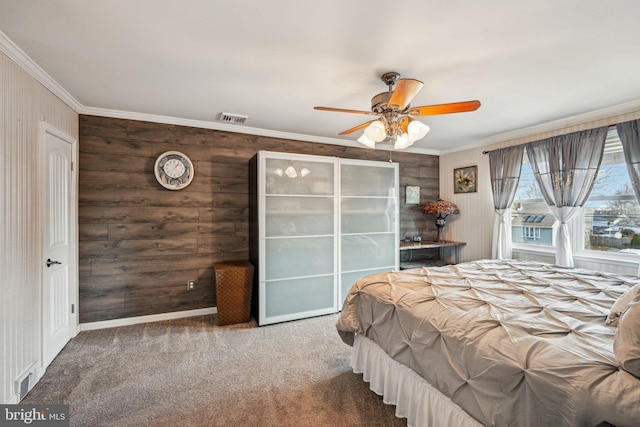 carpeted bedroom featuring ornamental molding and ceiling fan