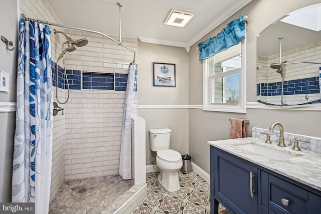 bathroom with crown molding, vanity, a shower with curtain, and toilet