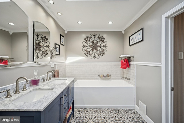 bathroom featuring ornamental molding, vanity, tile patterned floors, and a washtub