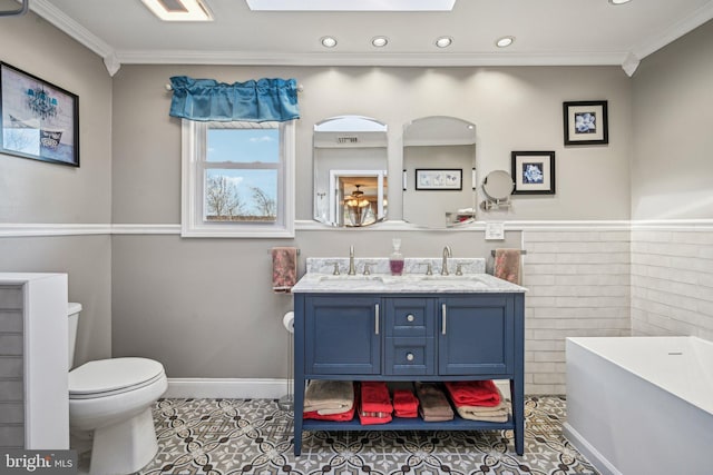 bathroom with tile patterned flooring, vanity, a bath, ornamental molding, and toilet