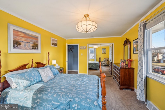 bedroom with crown molding and carpet floors