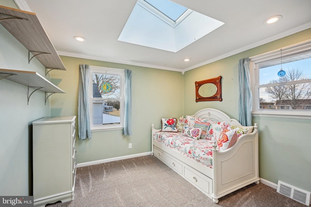 carpeted bedroom featuring ornamental molding and a skylight