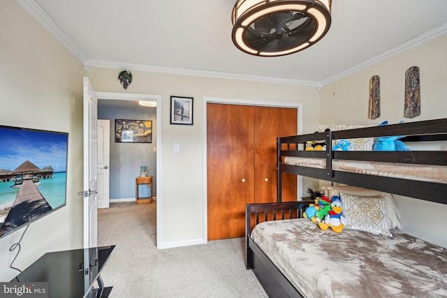 carpeted bedroom featuring ornamental molding and a closet