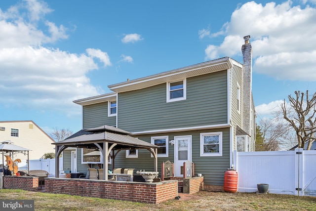 rear view of house featuring a gazebo and a patio area