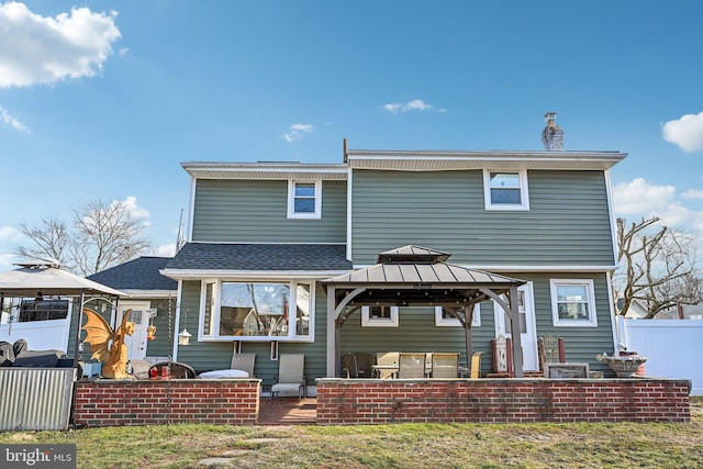 back of house featuring a gazebo, a yard, and a patio