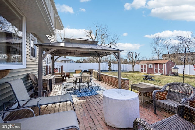 view of patio with a shed, a gazebo, and an outdoor hangout area