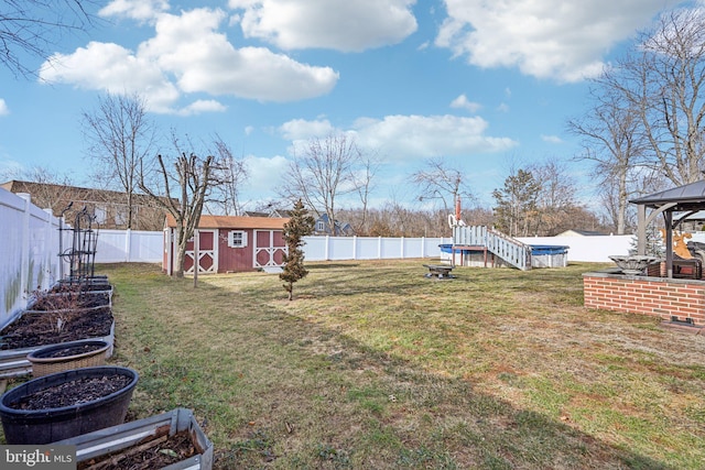 view of yard featuring a gazebo and a shed