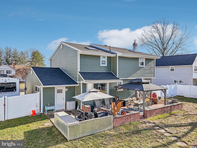 back of property featuring a gazebo, a yard, and a patio area