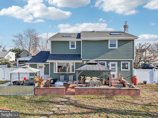 back of house featuring a gazebo, a yard, and a patio