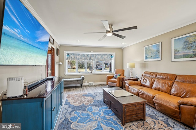 living room featuring hardwood / wood-style floors, crown molding, and ceiling fan