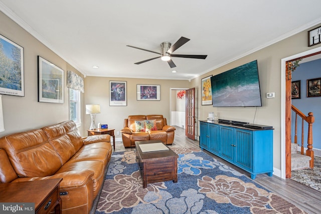 living room with wood-type flooring, ceiling fan, and crown molding