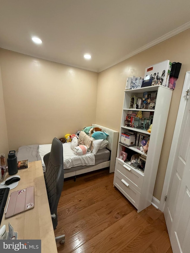 bedroom featuring crown molding and hardwood / wood-style floors