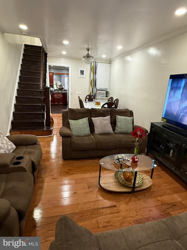 living room featuring crown molding and hardwood / wood-style floors