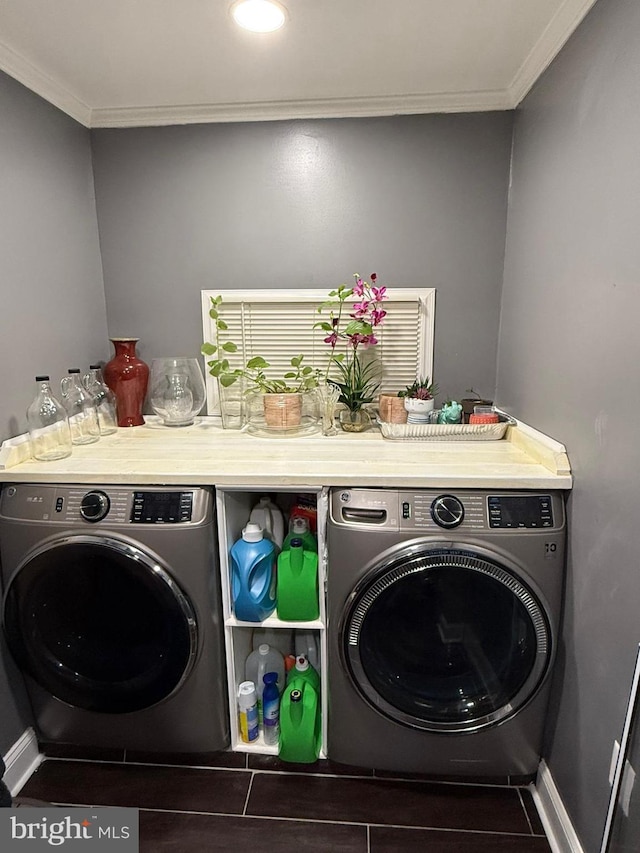 laundry room featuring ornamental molding and washing machine and clothes dryer