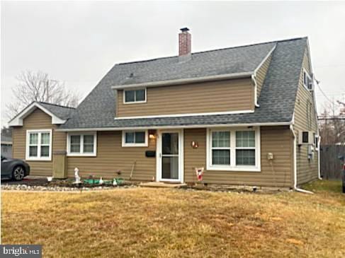 rear view of house with a lawn